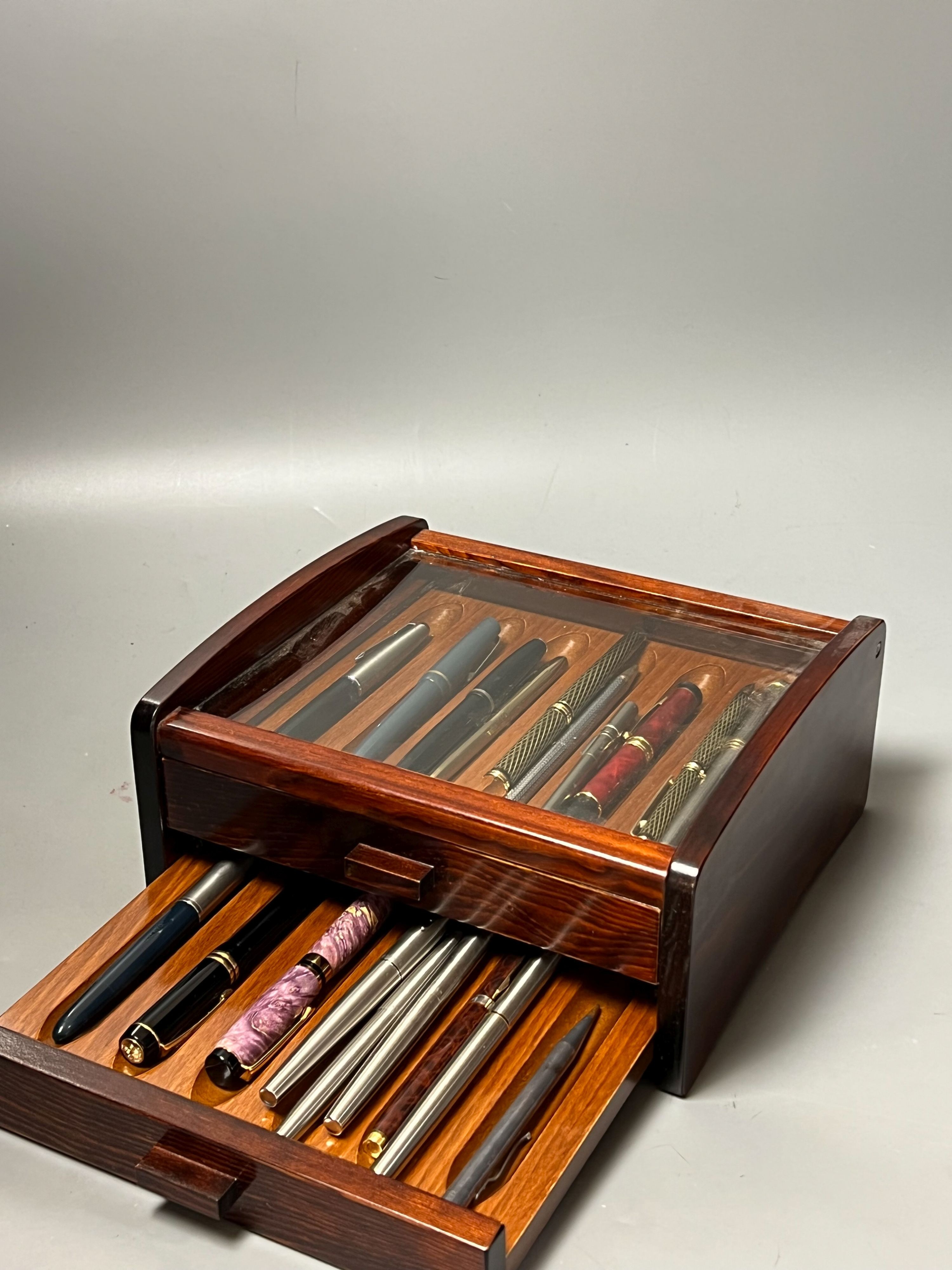 A group of various pens in display cabinet